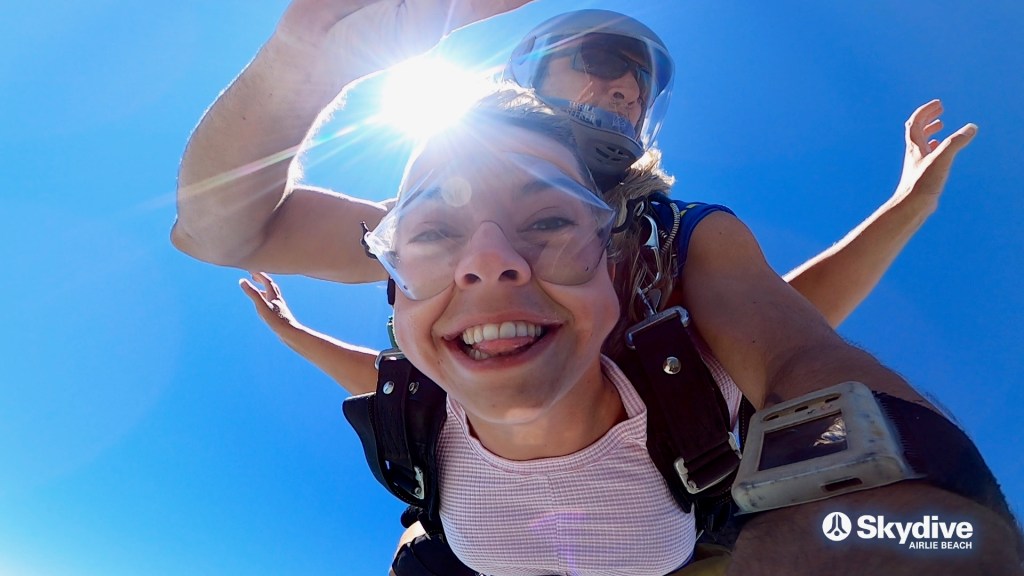 Sarah pulling a chipmunk face while skydiving.