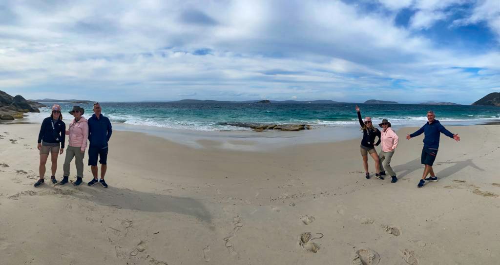 Sarah, her mum and dad on both sides of misery beach in a silly panoramic photo. 