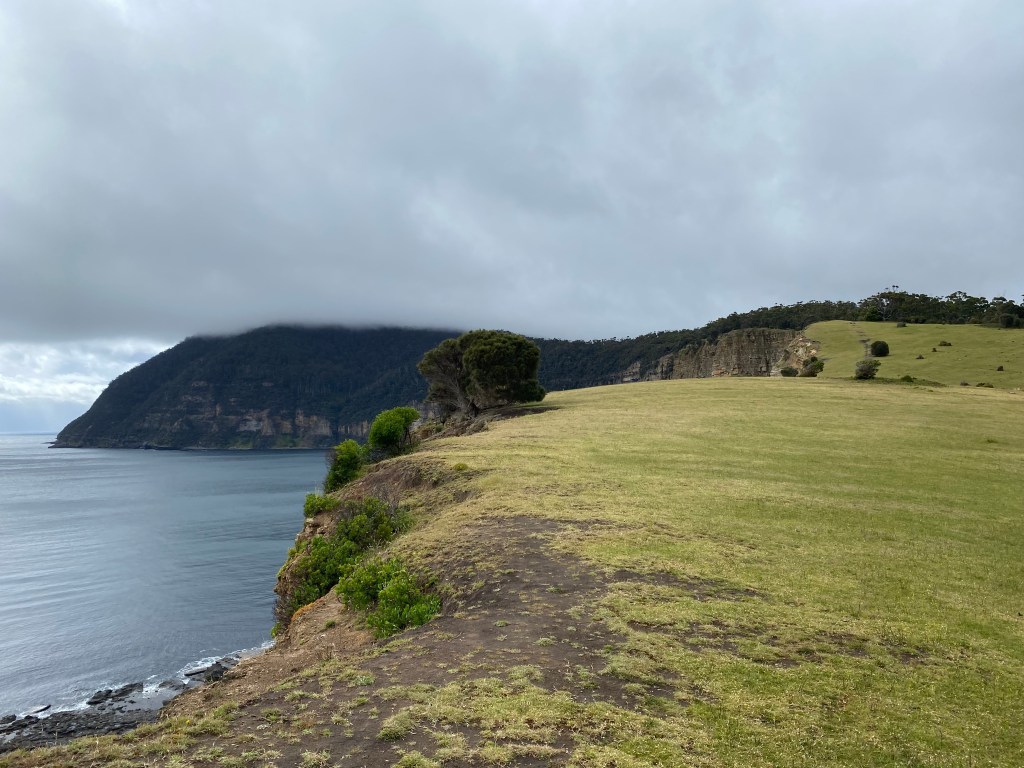 A moody grey sky low in the sky over bishop and clerk in the distance.