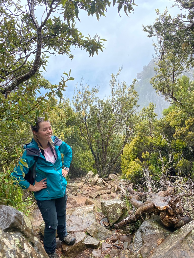 Sarah laughing while standing on the rocky path.