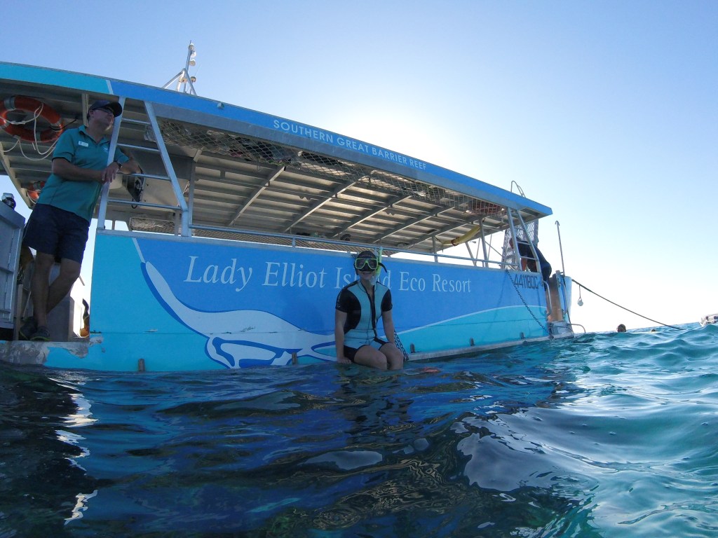 Sarah on the edge of the Lady Elliot Island Eco Resort glass bottom boat ready for a snorkel.